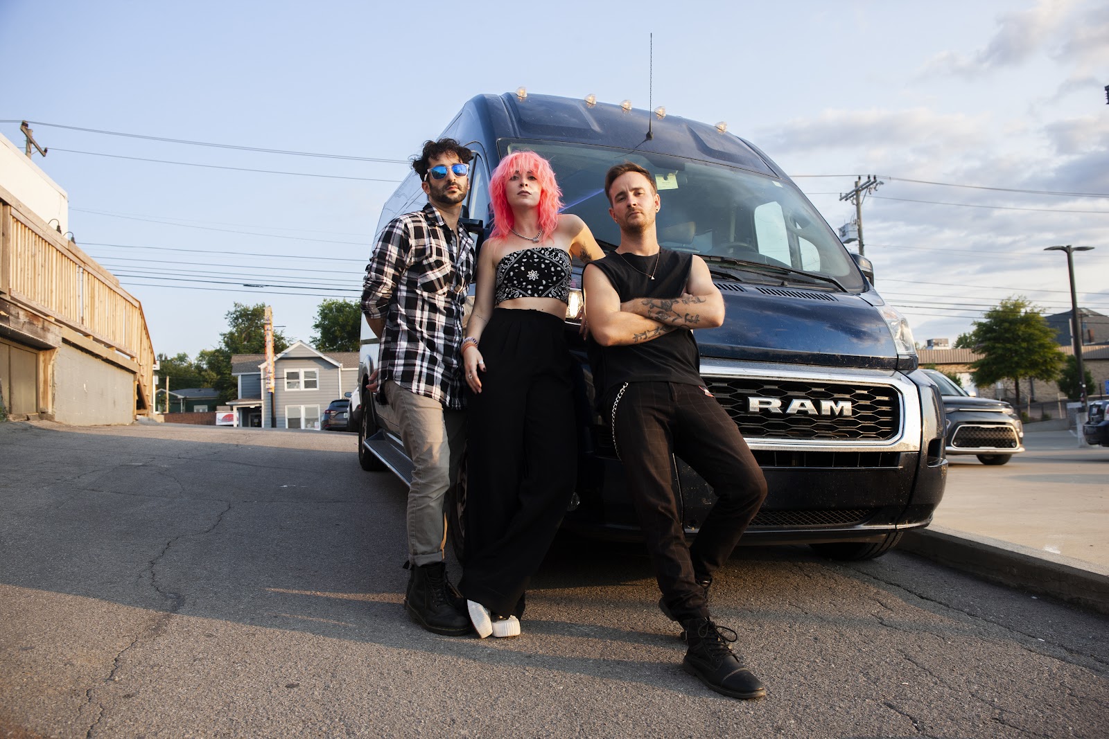 The Foxies pose by a navy blue RAM van.