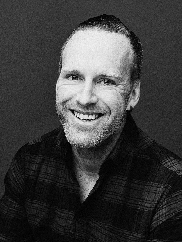 A black and white headshot of Christian Henderson.