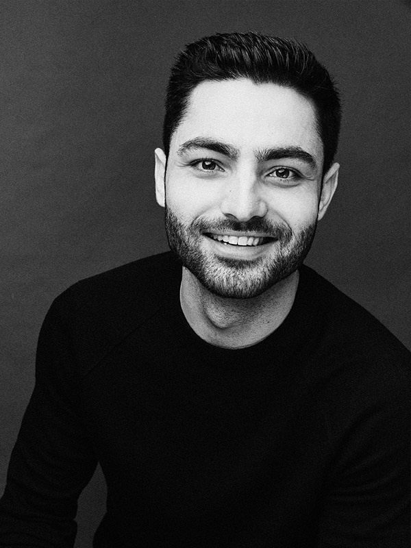 A black and white headshot of Dominic Karr.