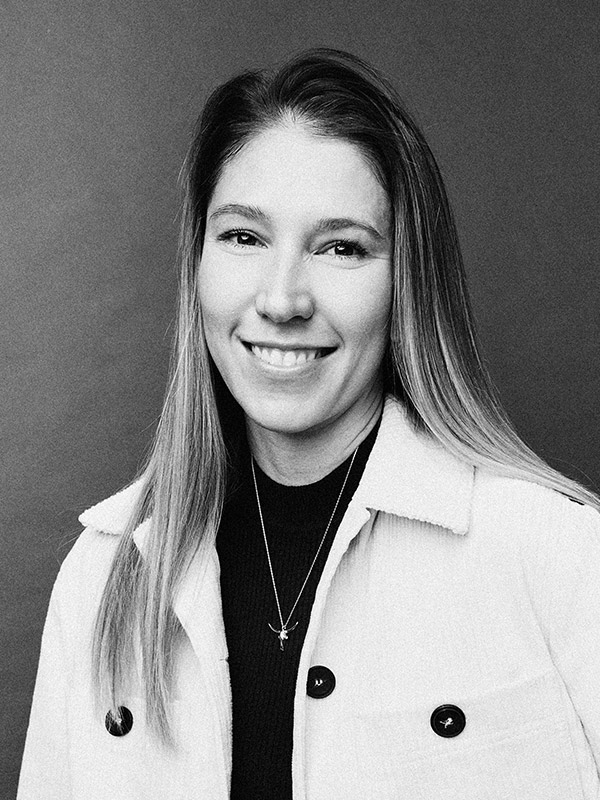 A black and white headshot of Emily Biner.