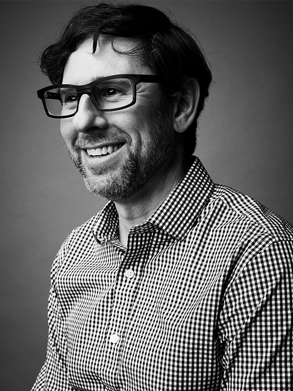 A black and white headshot of Matthew Umphlett.