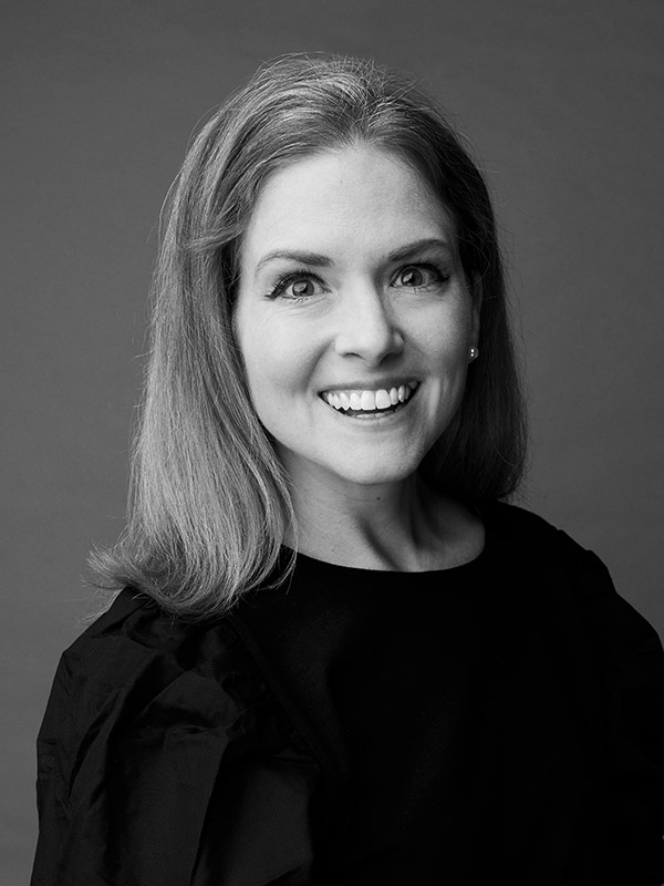 A black and white headshot of Sarah Romero.